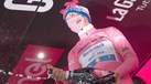 João Almeida holds up the pink jersey at the end of an exciting stage