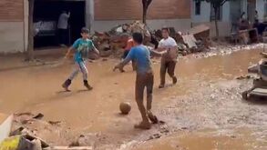 Um rasgo de esperança: crianças jogam à bola no meio da devastação de Valência