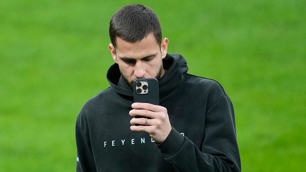 Jogador do Feyenoord concentrado no telemóvel