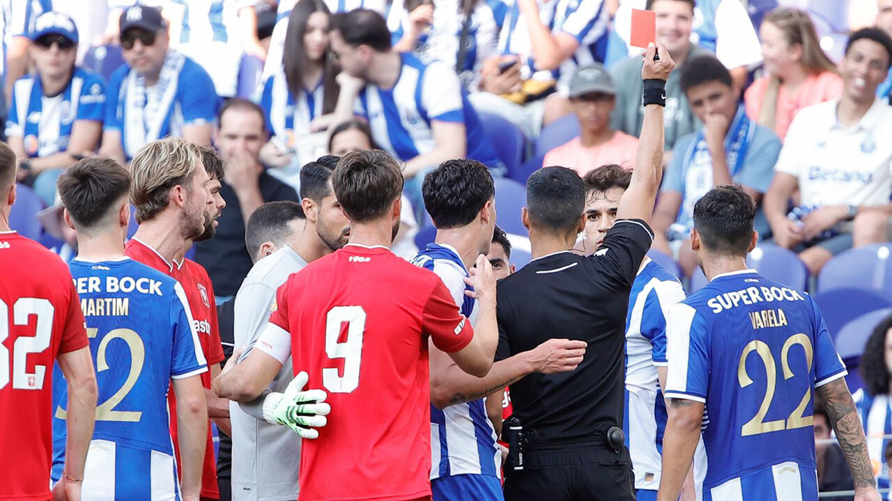 Árbitro exibe cartão vermelho durante jogo de futebol