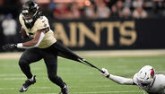 Jogador dos Saints escapa à defesa num jogo de futebol americano
