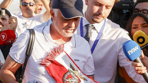 Mourinho à chegada a Lisboa com cachecol do Benfica