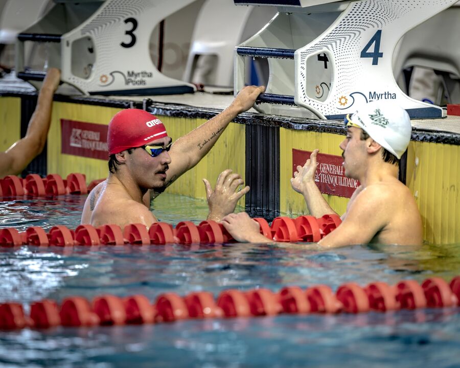 Nadadores preparam-se para competir numa piscina