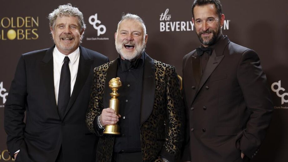 Os produtores John Wells e R. Scott Gemmill com o ator Noah Wyle exibem o troféu ganho por 'The Pitt' 
