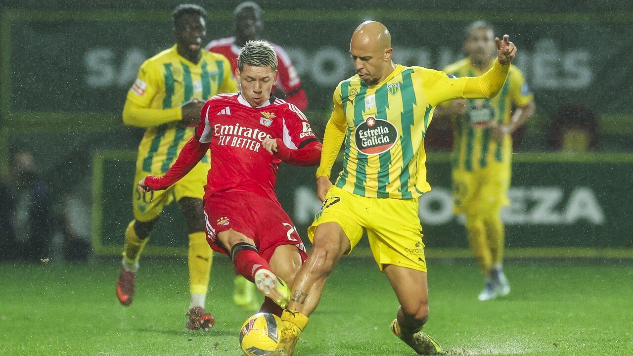 Jogo de futebol entre Benfica e Estoril sob chuva