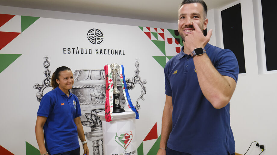 Técnico e jogadora piscam o olho ao troféu