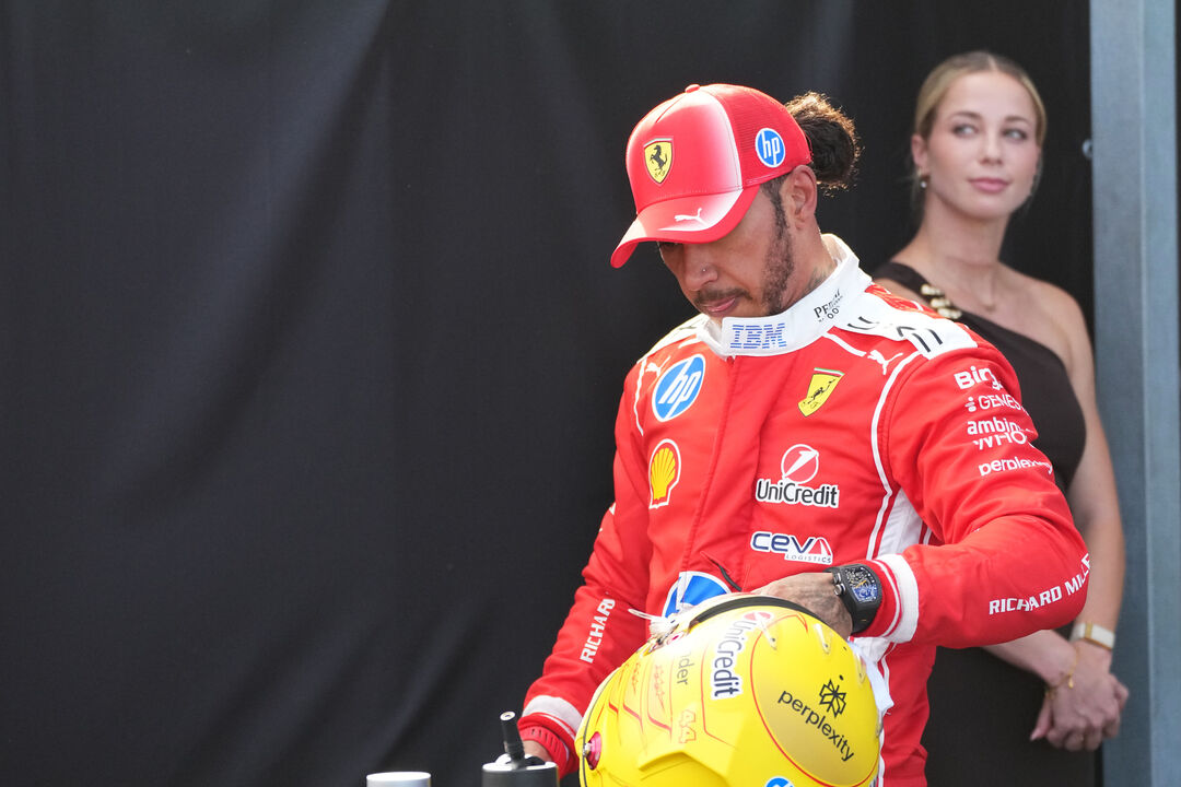 Ferrari driver Lewis Hamilton of Britain walks after the qualifying session ahead of Sunday's Formula One Hungarian Grand Prix auto