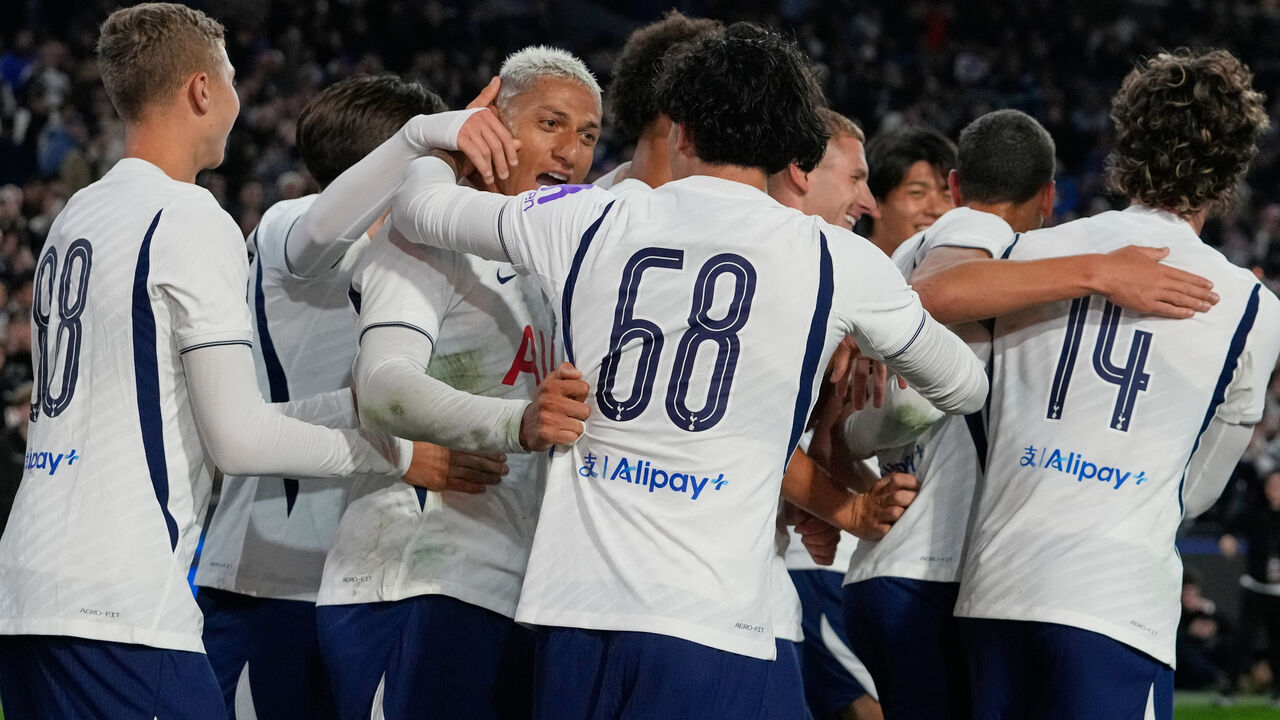 Tottenham's Richarlison, third left, is congratulated by teammates after scoring his team's second goalduring a friendly soccer match between Tottenham