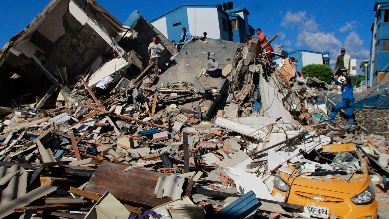 Residents search through the rubble after an earthquake struck Pereira, Colombia, Monday, Aug. 10, 2026. (AP Photo/Miguel Angel Lopez)