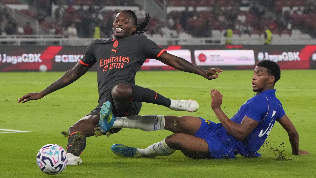 AC Milan's Rafael Leao, left, vies for the ball with Chelsea's Josh Acheampong during a pre-season friendly soccer match between