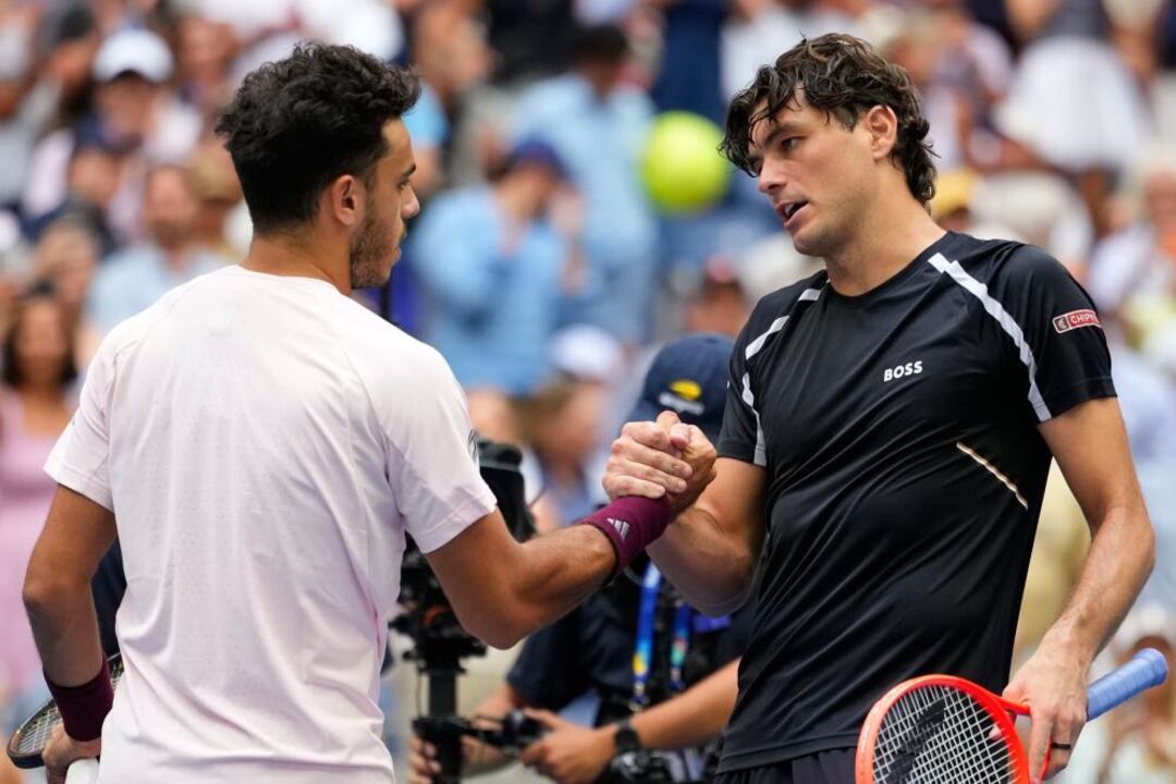 Taylor Fritz, of the United States, right, greets Francisco Cerundolo,