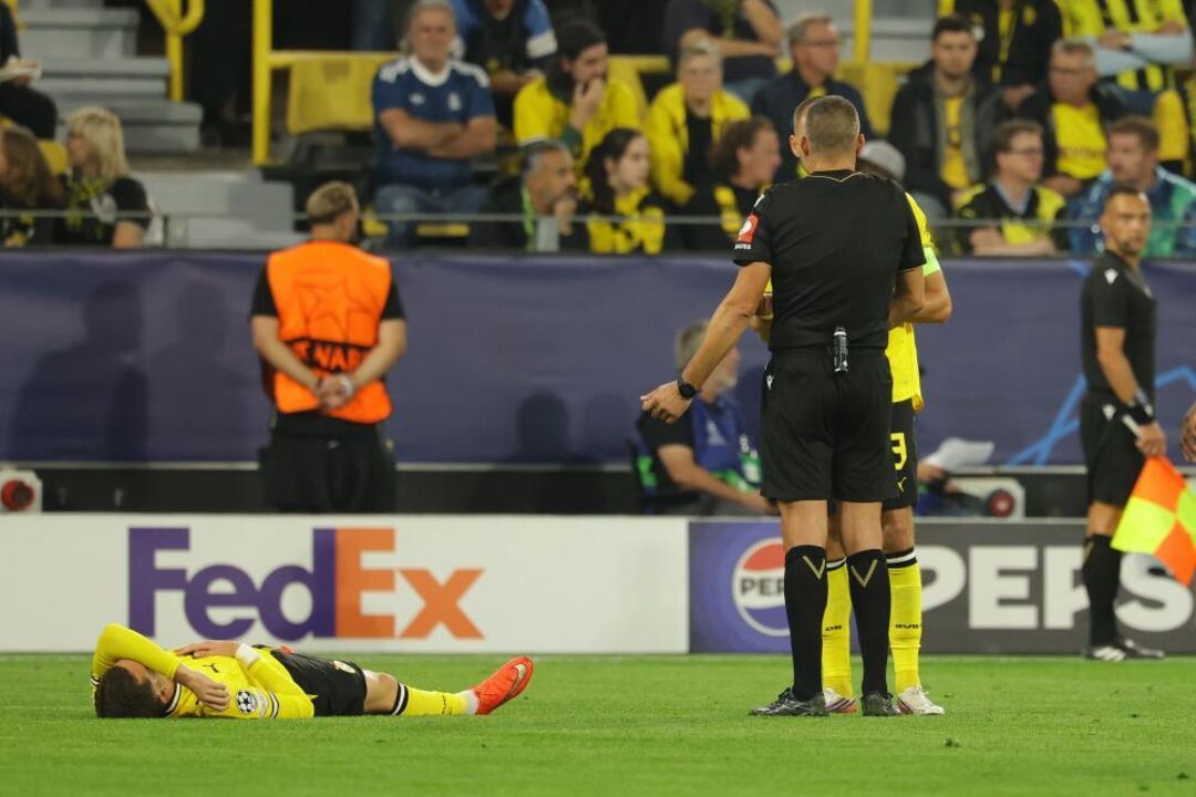 Konstantinos Karetsas of Dortmund lays on the ground injured during