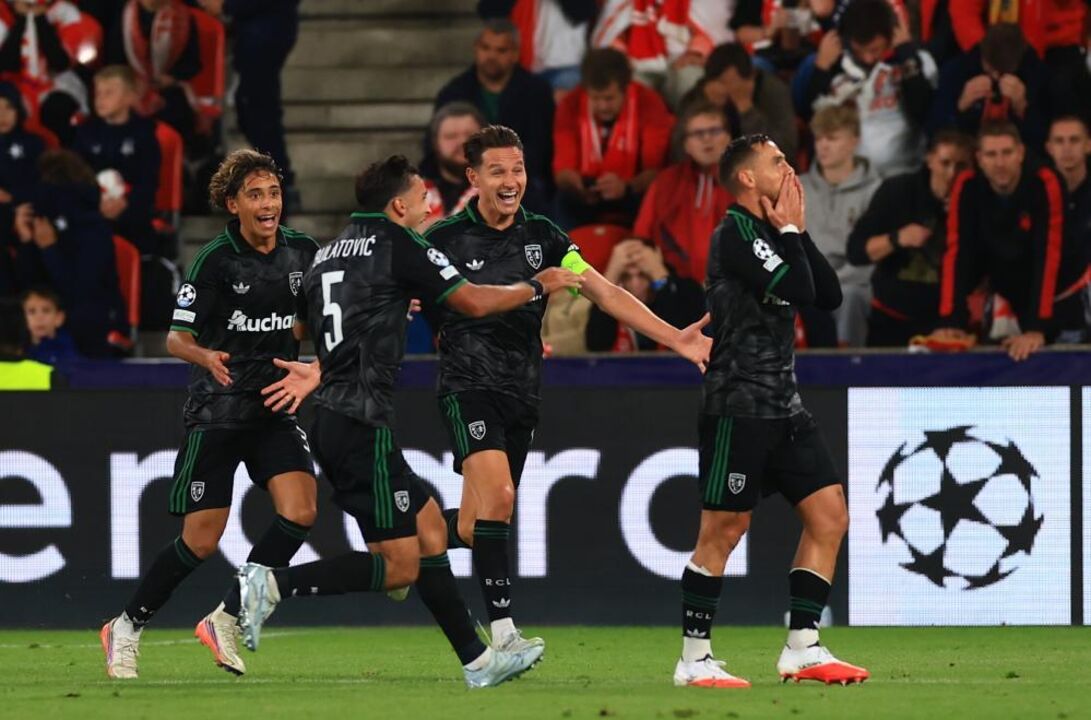 Ruben Aguilar of RC Lens (R) celebrates with teammates after