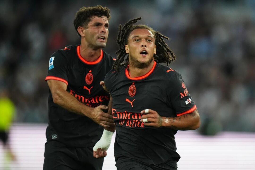 AC Milan's Diego Moreira, right, celebrates after he scored his