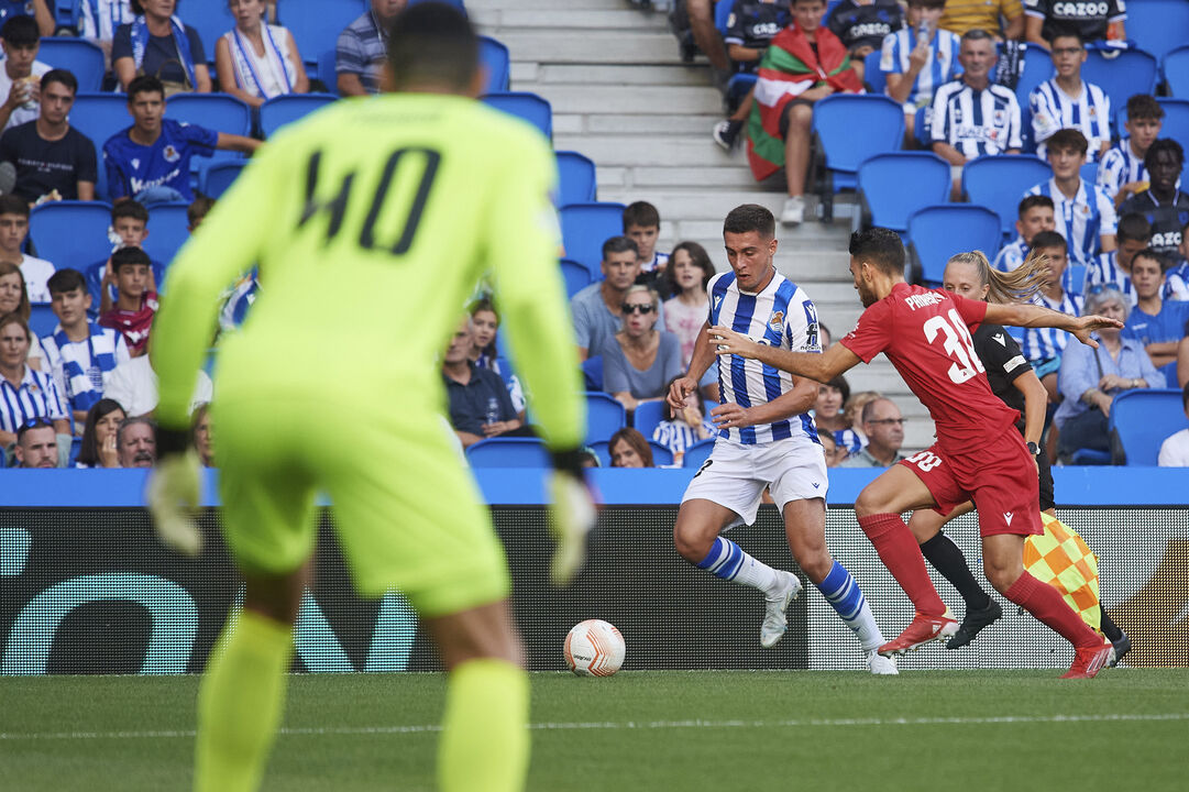 Real Sociedad's Jon Karrikaburu, left, challenges for the ball with Omonia's Nikolas Panayiotou during the Europa League Group E soccer