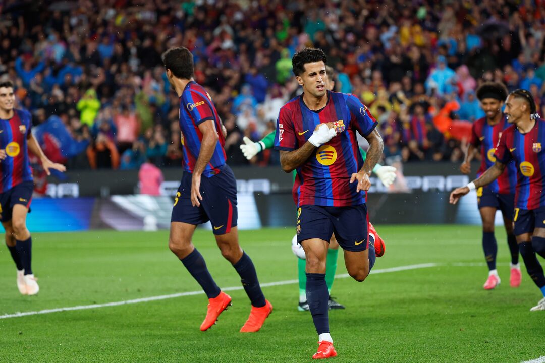 Barcelona's Joao Cancelo celebrates after scoring the opening goal during a Spanish La Liga soccer match between Barcelona and Racing