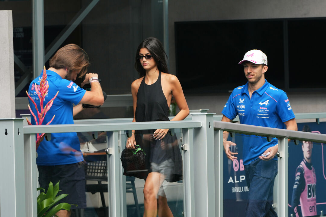 Alpine driver Pierre Gasly, right, of France arrives with Francisca "Kika" Cerqueira Gomes before a sprint auto race at the