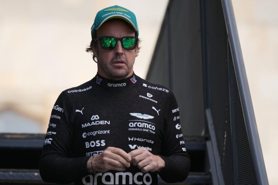 Aston Martin driver Fernando Alonso of Spain walks through the