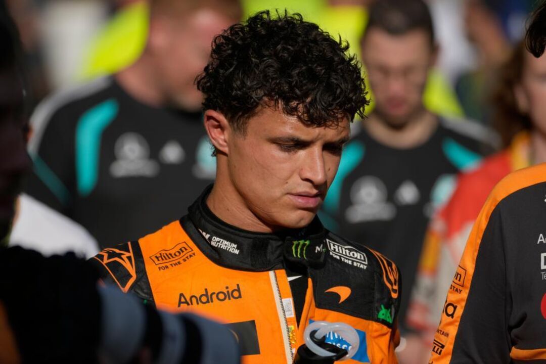 McLaren driver Lando Norris of Britain walks down pit lane