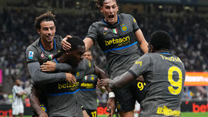 Inter Milan's Ange-Yoan Bonny, center, celebrates with teammates after scoring his sides fifth goal during the Serie A soccer match