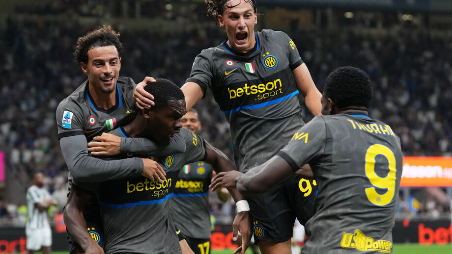 Inter Milan's Ange-Yoan Bonny, center, celebrates with teammates after scoring his sides fifth goal during the Serie A soccer match