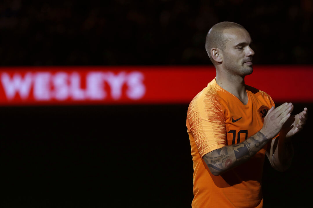 FILE - Wesley Sneijder of The Netherlands greets fans as he walks off the pitch as he retires from international