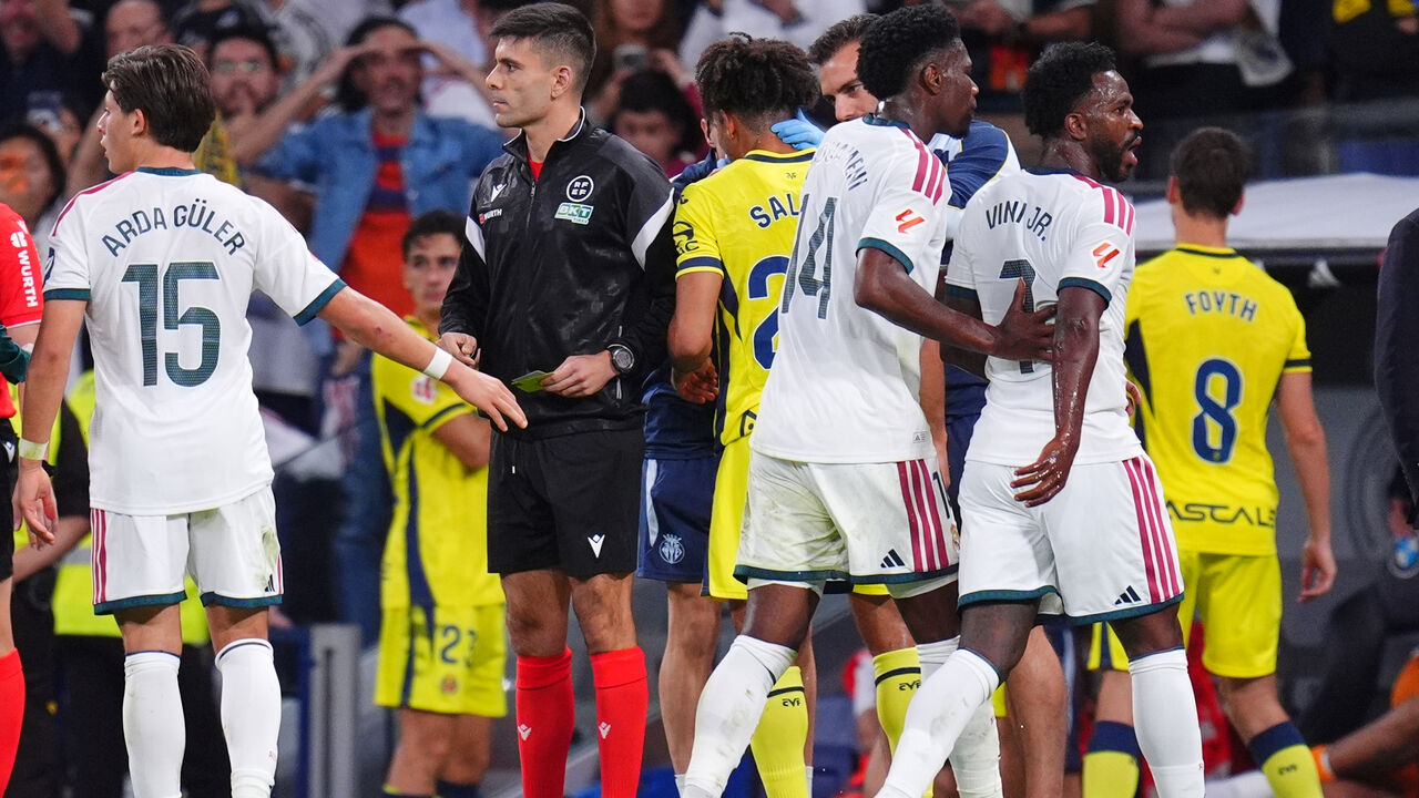 Real Madrid's Vinicius Junior, right, leaves the pitch after being shown a red card during the La Liga soccer match