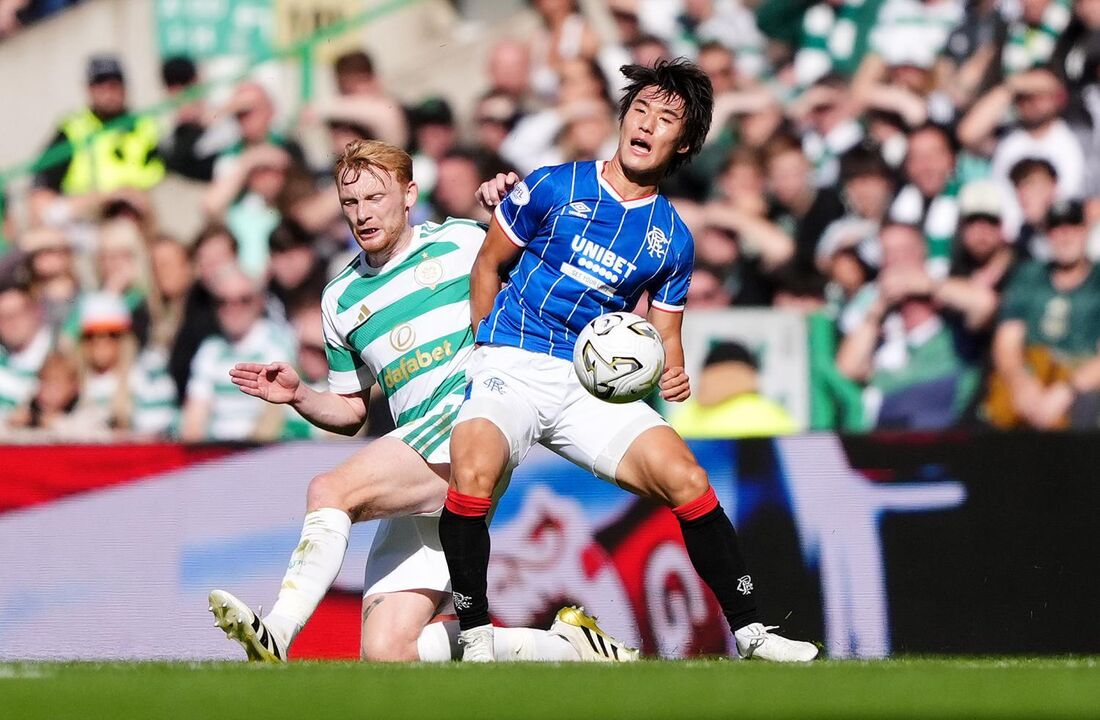 Celtic's Liam Scales, left, and Rangers' Kim Min-su battle for