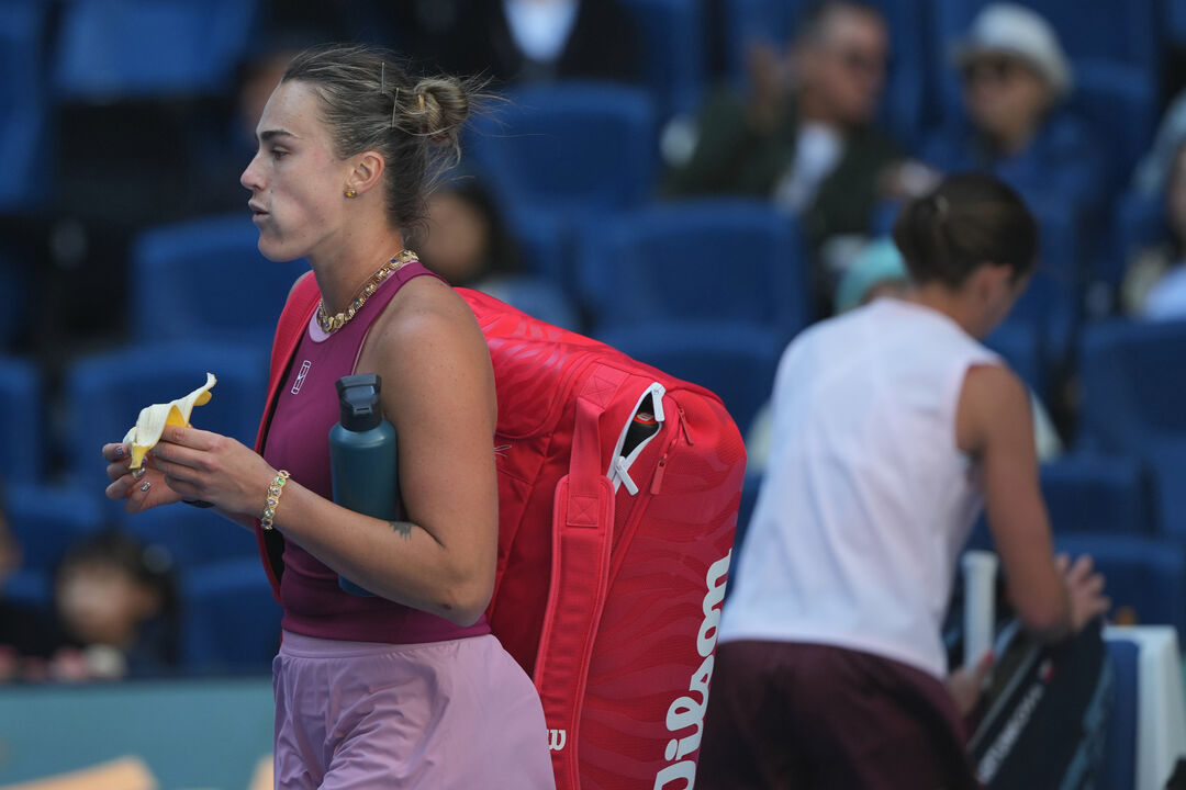 Aryna Sabalenka, of Belarus, left, leaves the court after lost in the third round of the women's singles match to