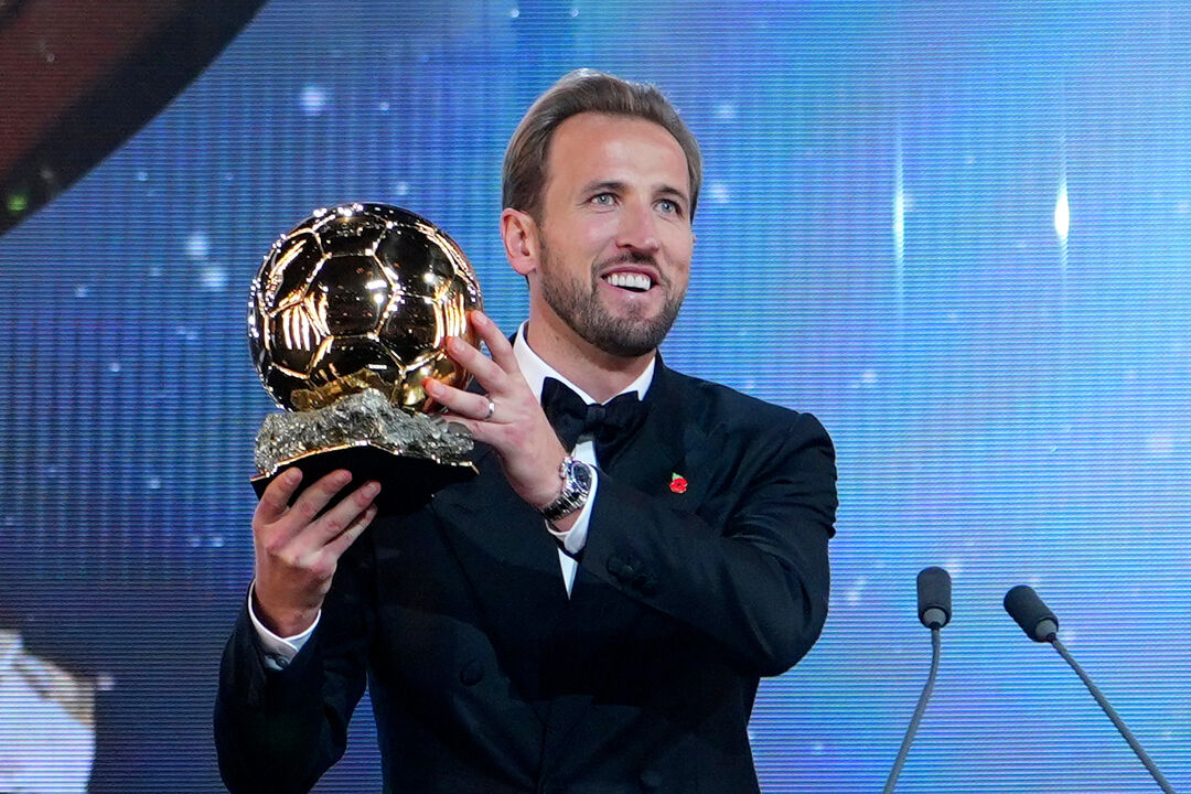 England's soccer player Harry Kane holds the player of the year trophy during the Ballon d'Or ceremony at the London