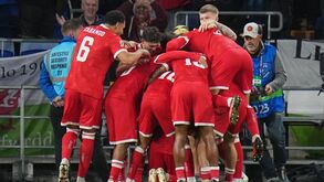 Wales' Neco Williams, hidden, celebrates with his team after he
