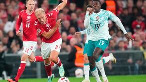 Denmark's Gustav Isaksen, left, and Portugal's Nuno Mendes in action